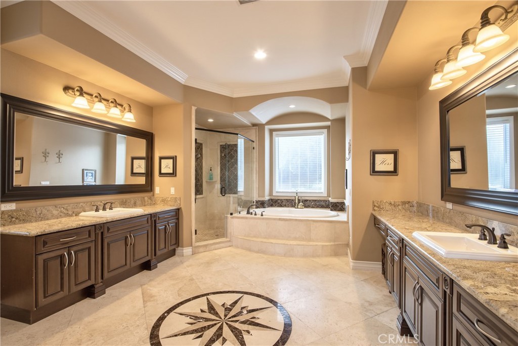 44195 Vía Horca Temecula, CA 92590 - Photo 27 of 74 a large bathroom with a granite countertop tub a double vanity sink and a large mirror