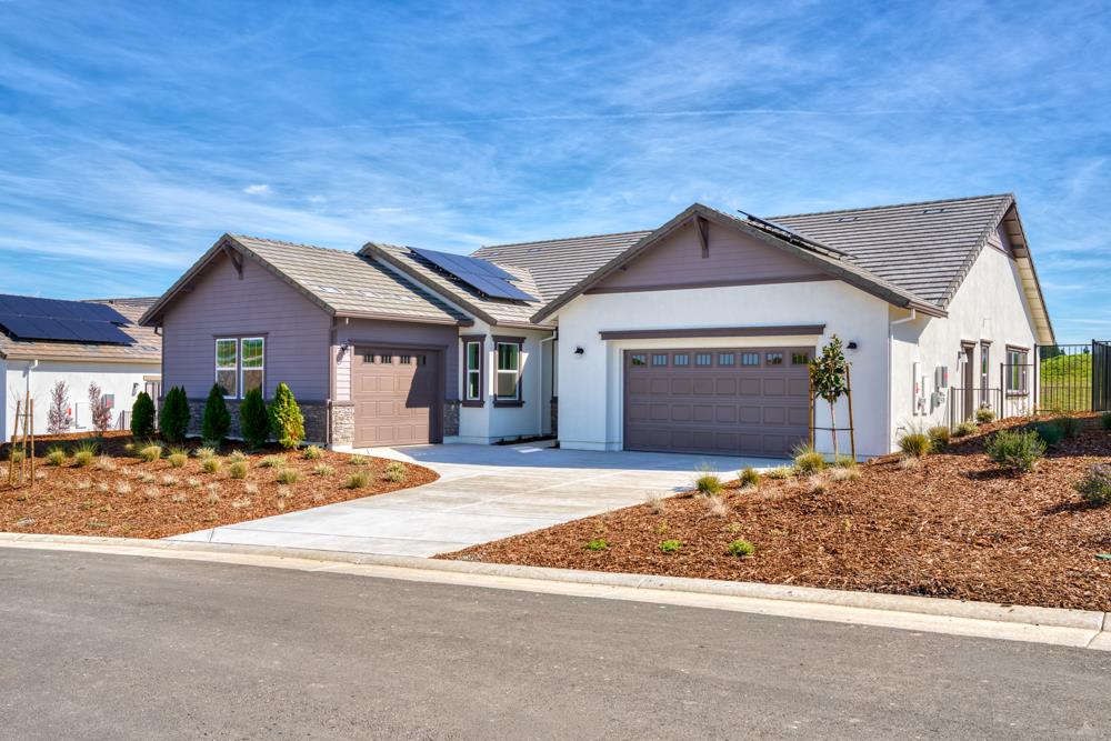 14838 Grace Warren Way Rancho Murieta, CA 95683 - Photo 1 of 18 a front view of a house with a yard and garage