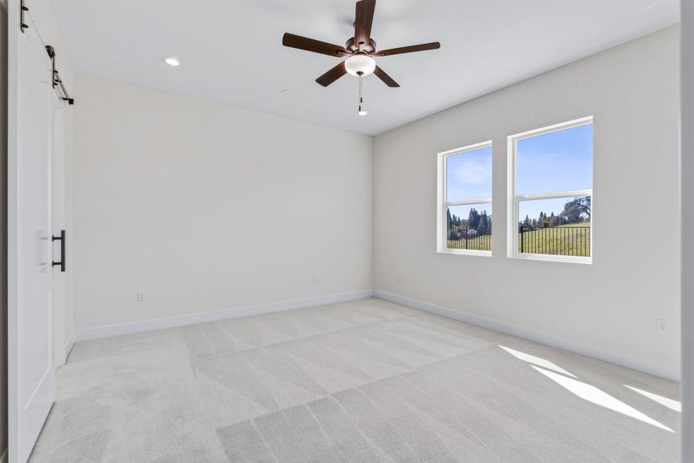 14838 Grace Warren Way Rancho Murieta, CA 95683 - Photo 12 of 18 an empty room with windows and fan