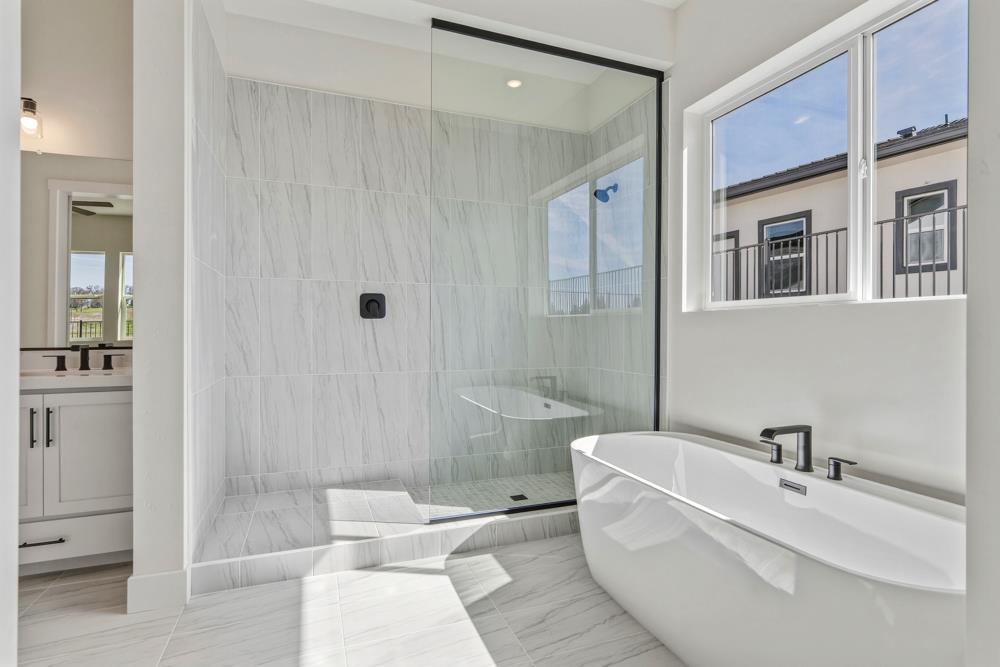 14838 Grace Warren Way Rancho Murieta, CA 95683 - Photo 16 of 18 a bathroom with a sink a toilet and shower