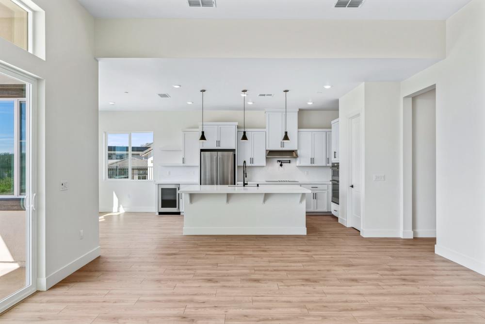 14838 Grace Warren Way Rancho Murieta, CA 95683 - Photo 5 of 18 a view of kitchen with wooden floor