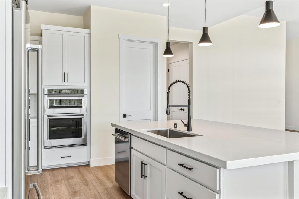 14838 Grace Warren Way Rancho Murieta, CA 95683 - Photo 7 of 18 a kitchen with granite countertop a stove and a sink