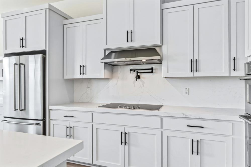 14838 Grace Warren Way Rancho Murieta, CA 95683 - Photo 9 of 22 a kitchen with stainless steel appliances white cabinets and a refrigerator