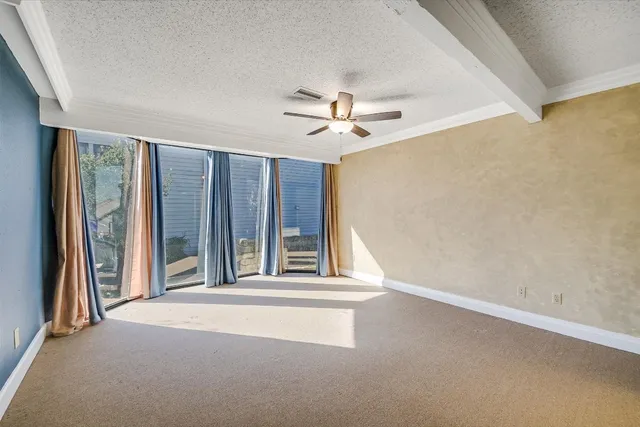 a view of a livingroom with a ceiling fan and window