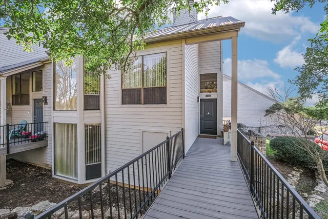 a view of a house with wooden deck