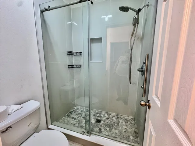 a bathroom with a shower and a toilet