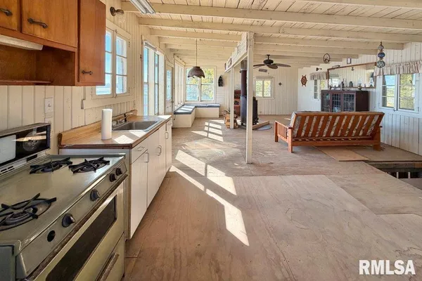 a kitchen with stainless steel appliances granite countertop a stove a sink and a refrigerator