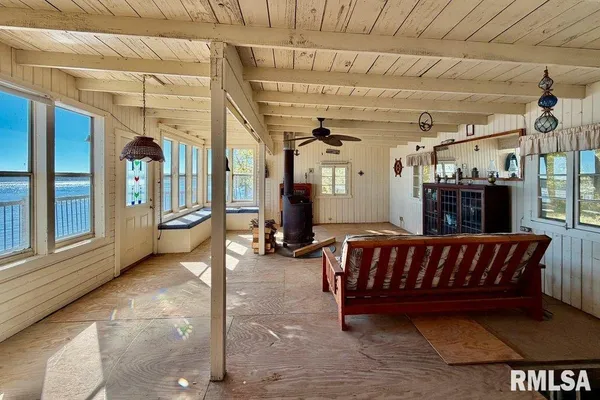 a view of a porch with furniture and a yard