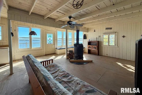 a dining room with furniture a chandelier and wooden floor