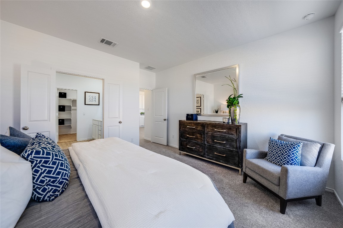 1819 Bear Grass Rdg Road Temple, TX 76501 - Photo 21 of 23 Bedroom with light carpet and ensuite bath