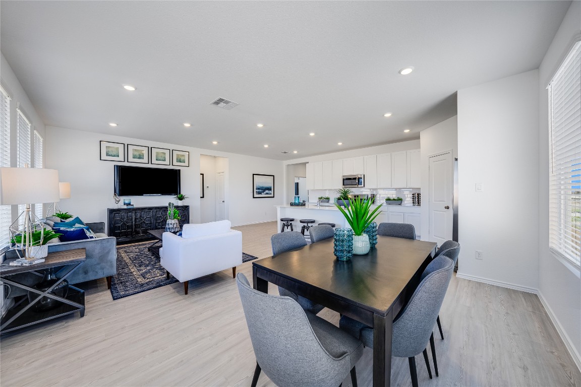 1819 Bear Grass Rdg Road Temple, TX 76501 - Photo 3 of 23 Dining area with plenty of natural light, light wood finished floors, recessed lighting, and a fireplace