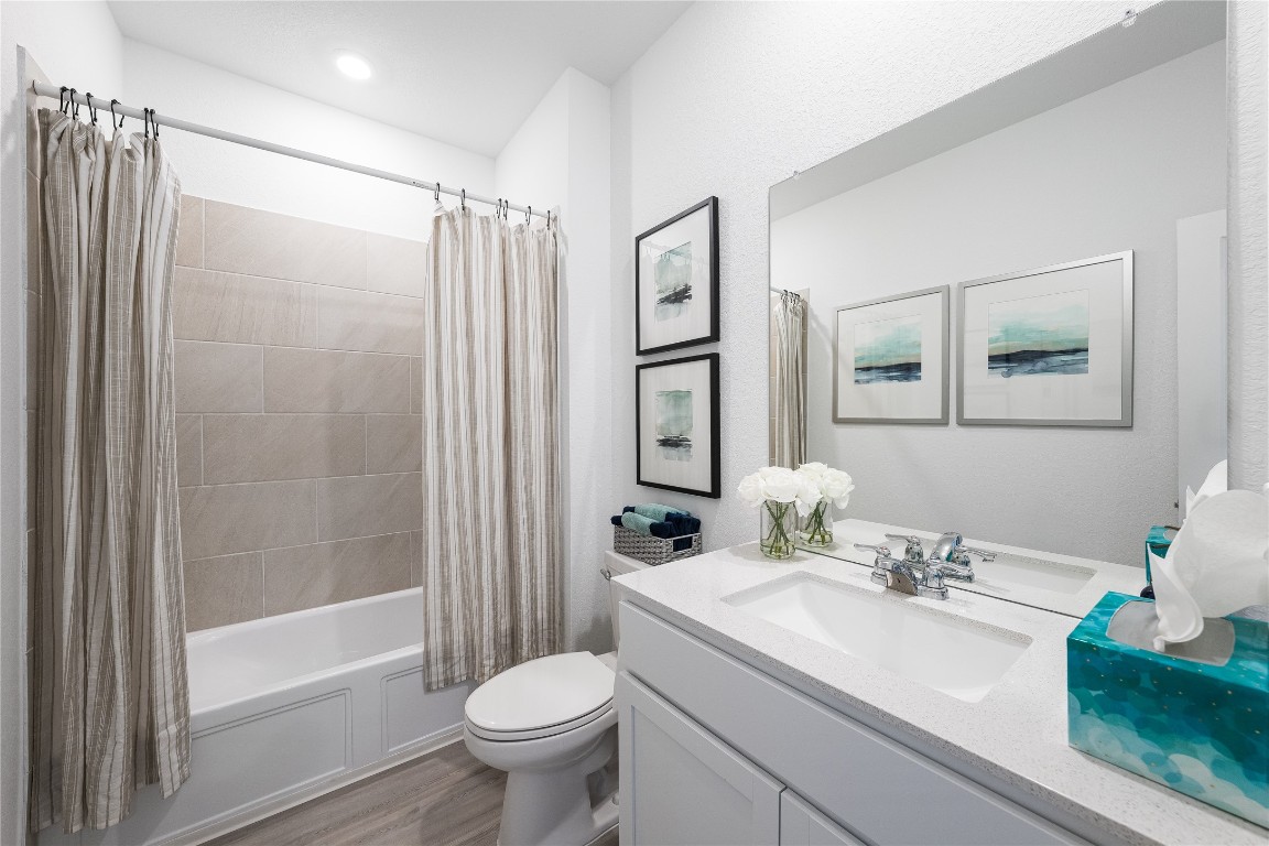 1819 Bear Grass Rdg Road Temple, TX 76501 - Photo 9 of 23 Full bath with shower / tub combo with curtain, vanity, and light wood-style floors