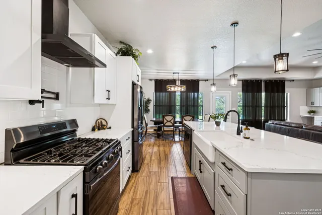 a kitchen with a stove a sink and a refrigerator