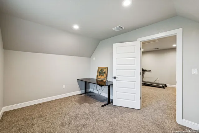 a view of a field with trees in the background