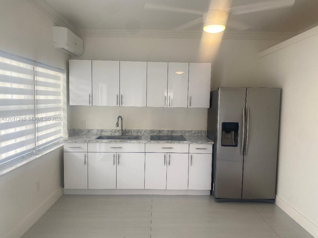 14640 Southwest 180th Street Miami, FL 33177 - Photo 3 of 6 a kitchen with stainless steel appliances granite countertop a sink and a refrigerator