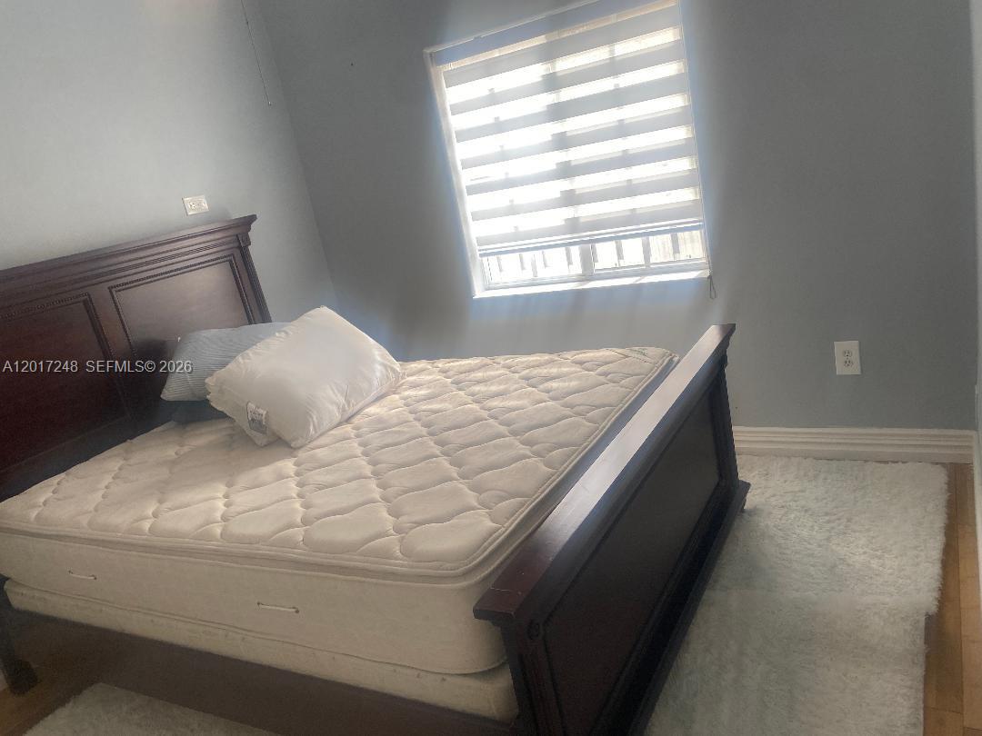 14640 Southwest 180th Street Miami, FL 33177 - Photo 4 of 6 a bedroom with a bed and window