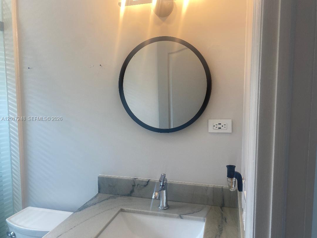 14640 Southwest 180th Street Miami, FL 33177 - Photo 6 of 6 a bathroom with a toilet and a sink