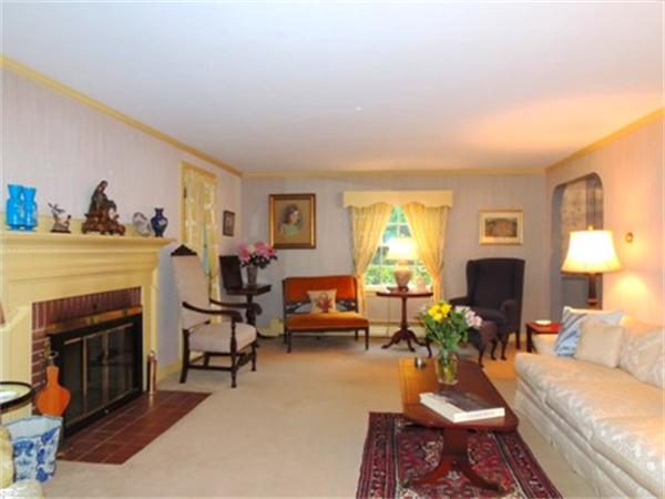 281 Lexington Road Concord, MA 01742 - Photo 2 of 16 a living room with furniture a fireplace and a large window
