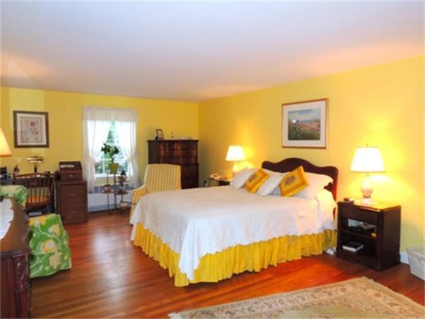 281 Lexington Road Concord, MA 01742 - Photo 5 of 16 a bedroom with a bed and wooden floor