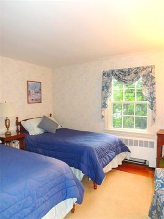 281 Lexington Road Concord, MA 01742 - Photo 7 of 16 a bedroom with a bed and a window