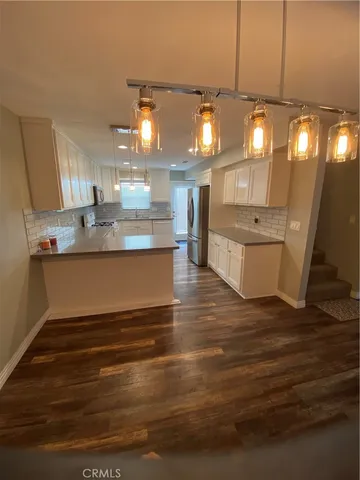 a living room with kitchen island granite countertop furniture and a kitchen view
