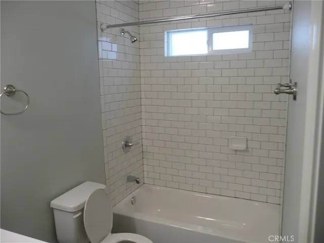 a bathroom with a toilet bathtub and shower