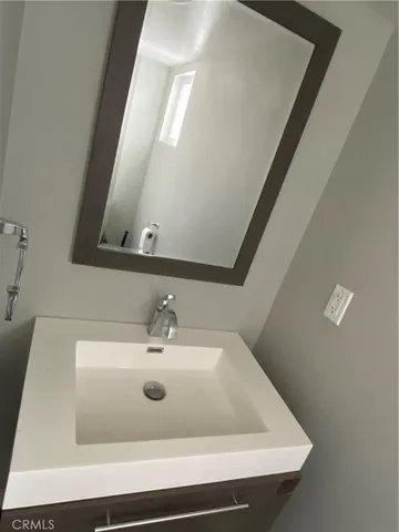 a bathroom with a sink and mirror