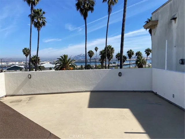 a view of a living room with furniture and potted plants
