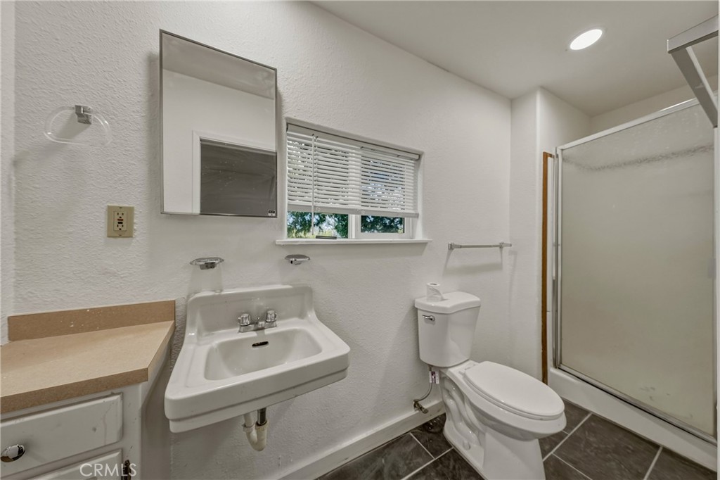 1980 Big Valley Road Lakeport, CA 95453 - Photo 26 of 56 a bathroom with a sink toilet a mirror and shower