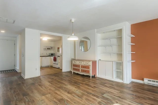 a view of a kitchen with wooden floor and a refrigerator