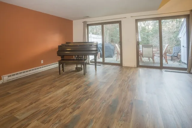 a view of a room with wooden floor and a window