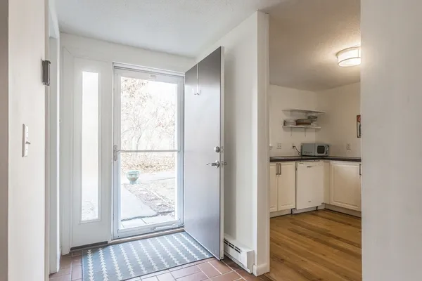 a view of kitchen with wooden floor and electronic appliances