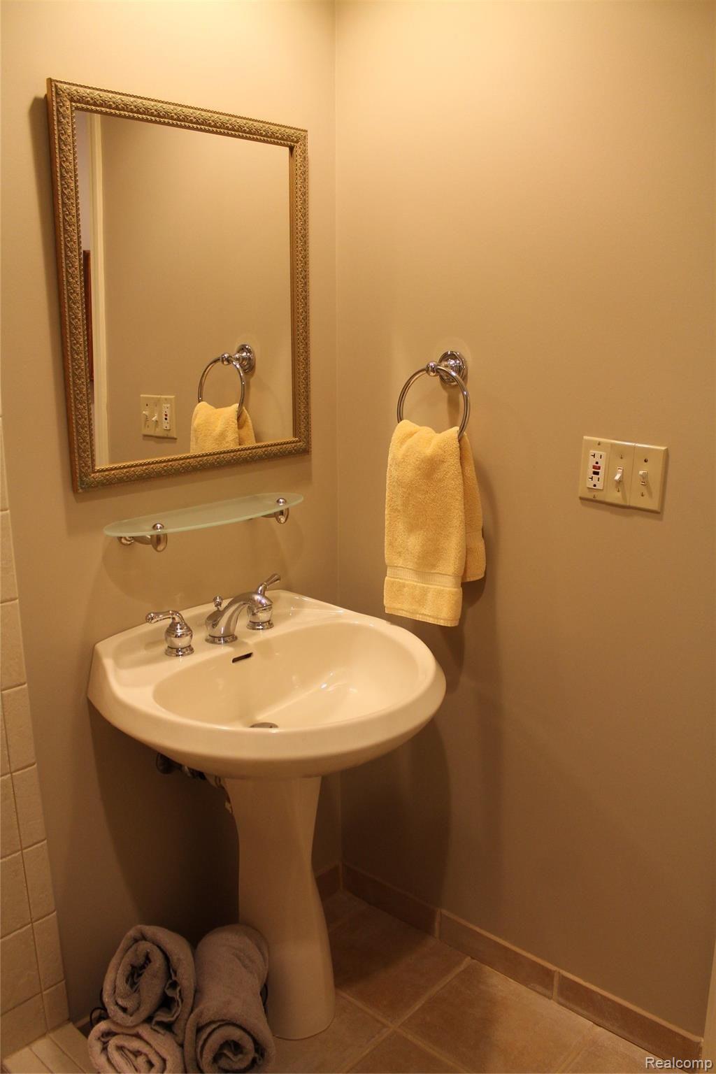2670 East Wardlow Road Highland, MI 48356 - Photo 39 of 99 pedestal sink in basement bathroom