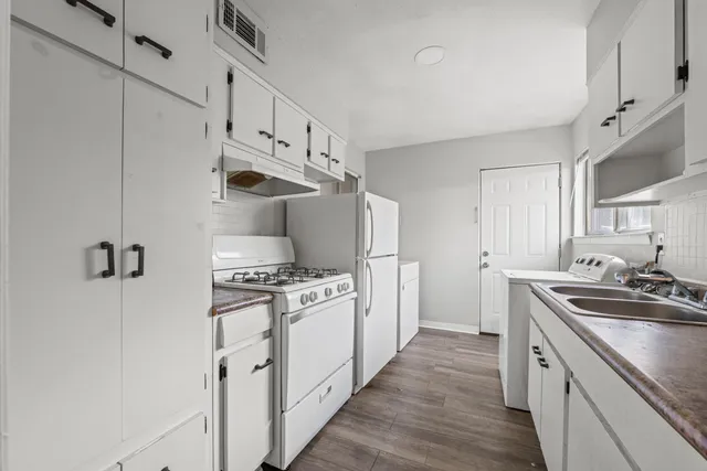 a kitchen with stainless steel appliances a sink stove and refrigerator