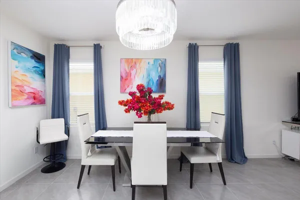 a kitchen with kitchen island a sink and a flat screen tv