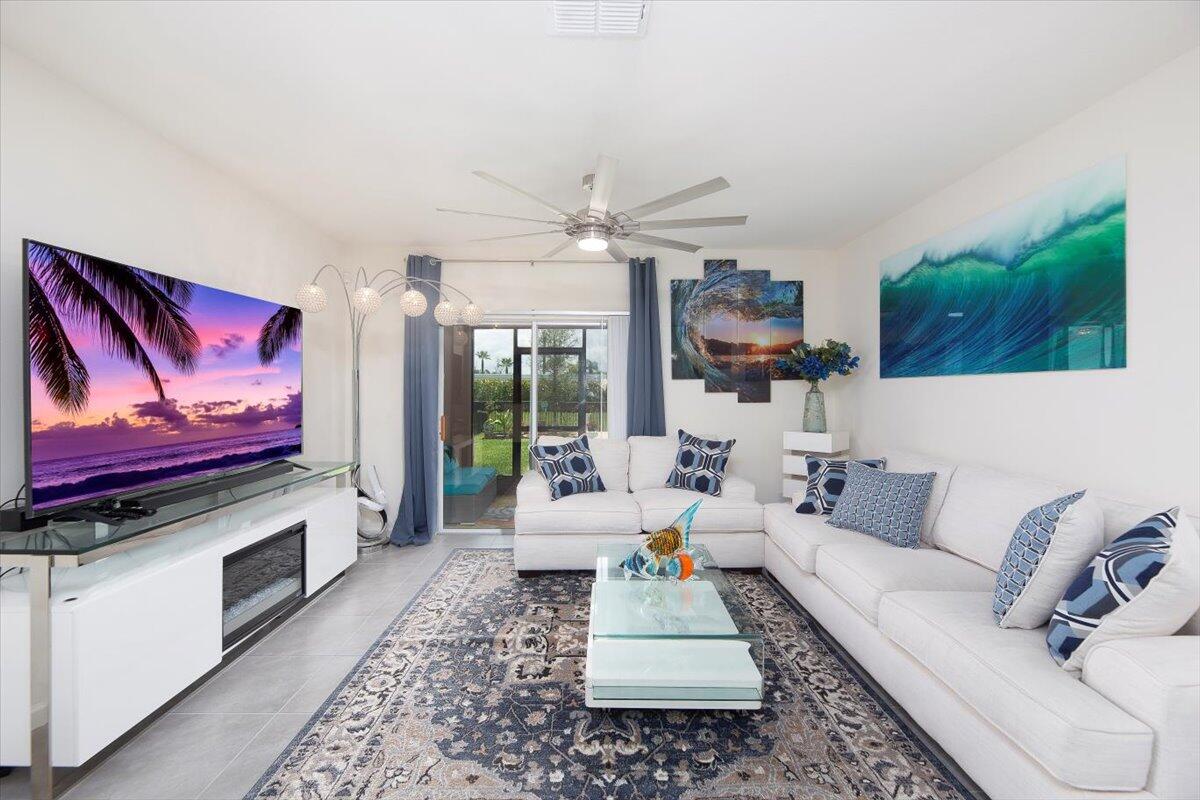 12314 Rimini Way Port St. Lucie, FL 34987 - Photo 17 of 49 a living room with furniture and a flat screen tv
