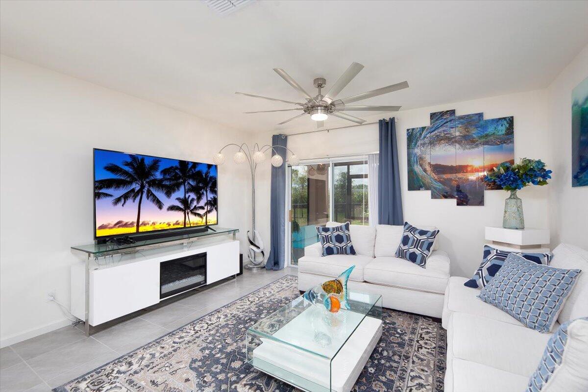 12314 Rimini Way Port St. Lucie, FL 34987 - Photo 18 of 49 a living room with furniture ceiling fan and a rug