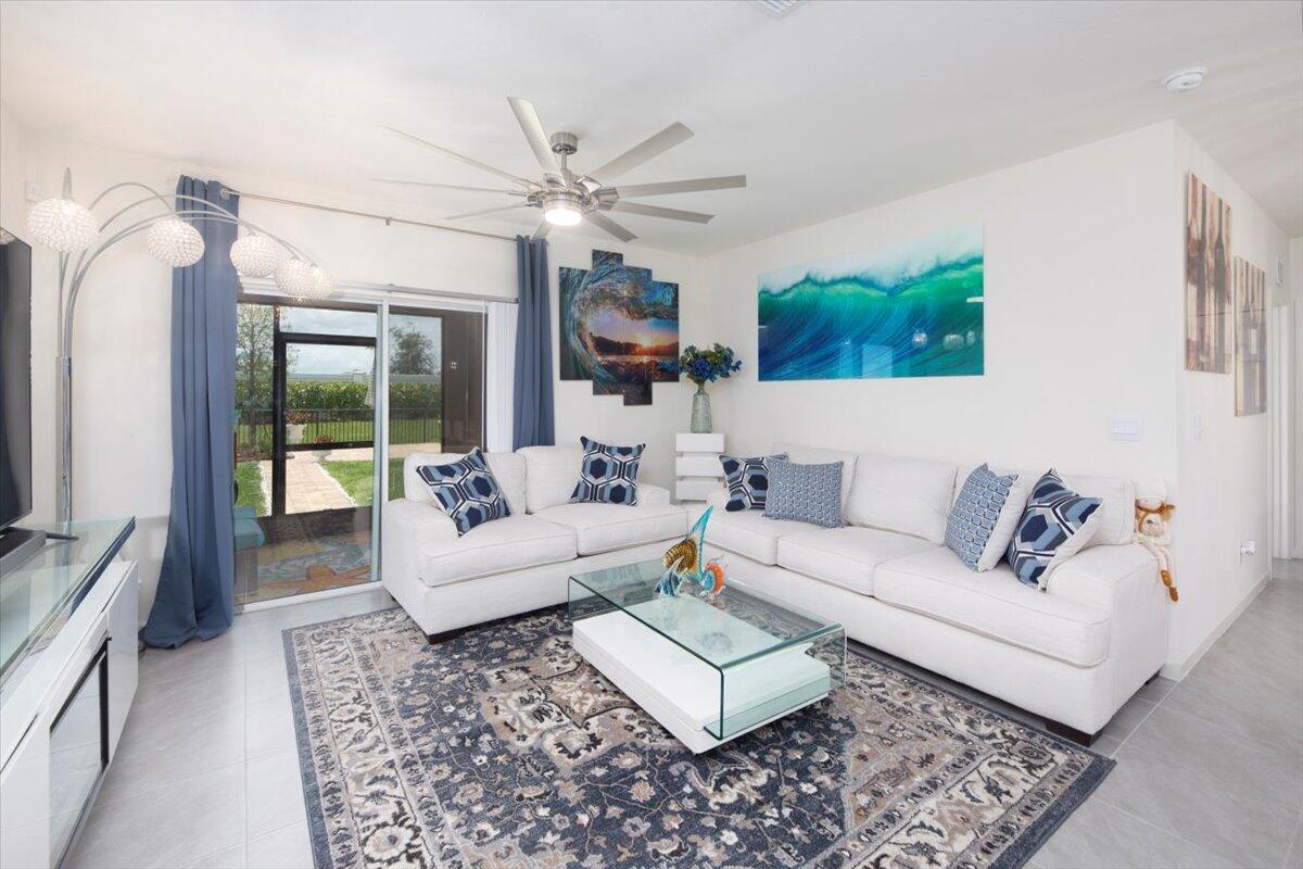 12314 Rimini Way Port St. Lucie, FL 34987 - Photo 19 of 49 a living room with furniture and a flat screen tv