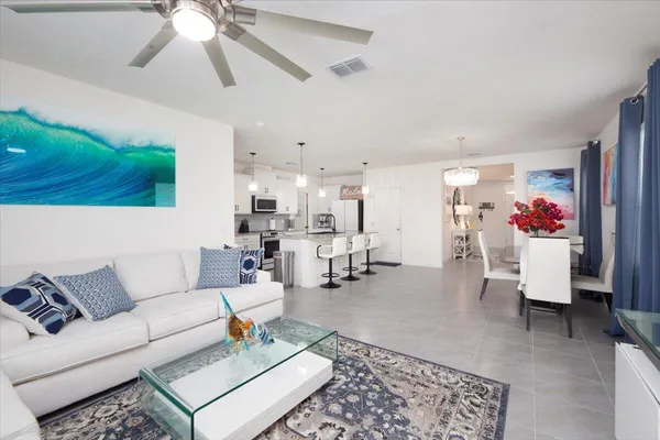 a living room with furniture and flowers