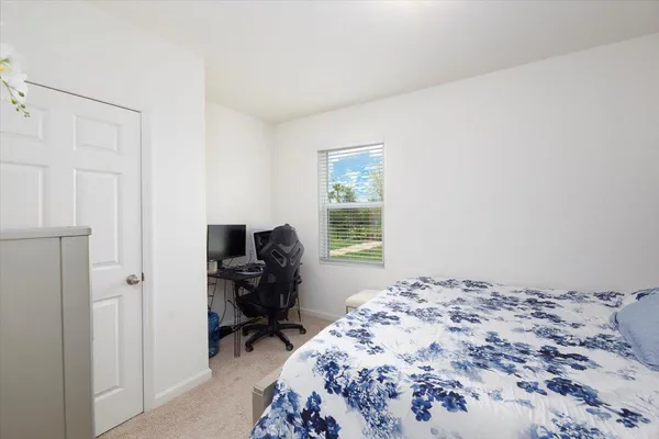 a bed room with a bed and a chair