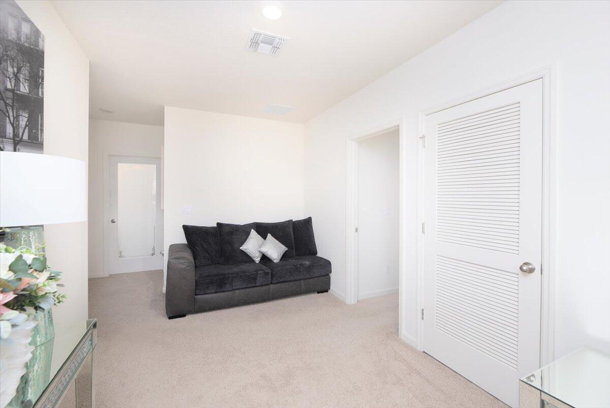 12314 Rimini Way Port St. Lucie, FL 34987 - Photo 24 of 49 a living room with furniture and flowers