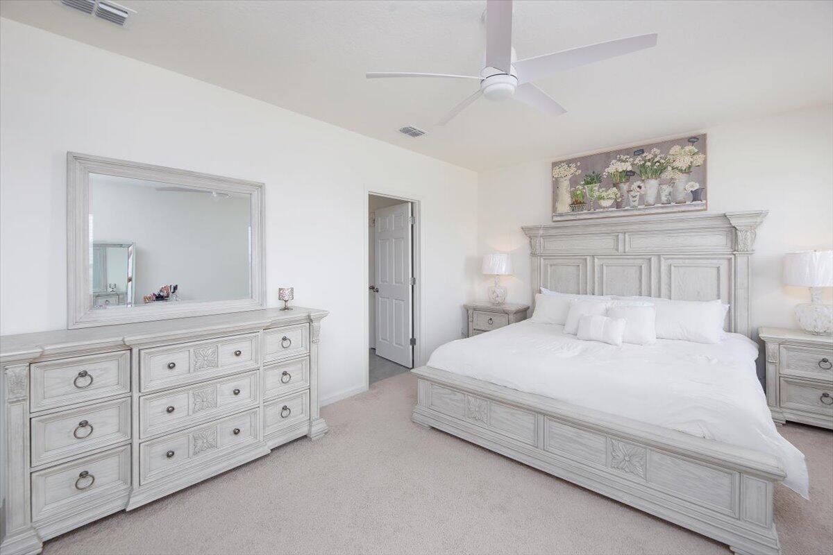 12314 Rimini Way Port St. Lucie, FL 34987 - Photo 27 of 49 a bedroom with a large bed and a dresser