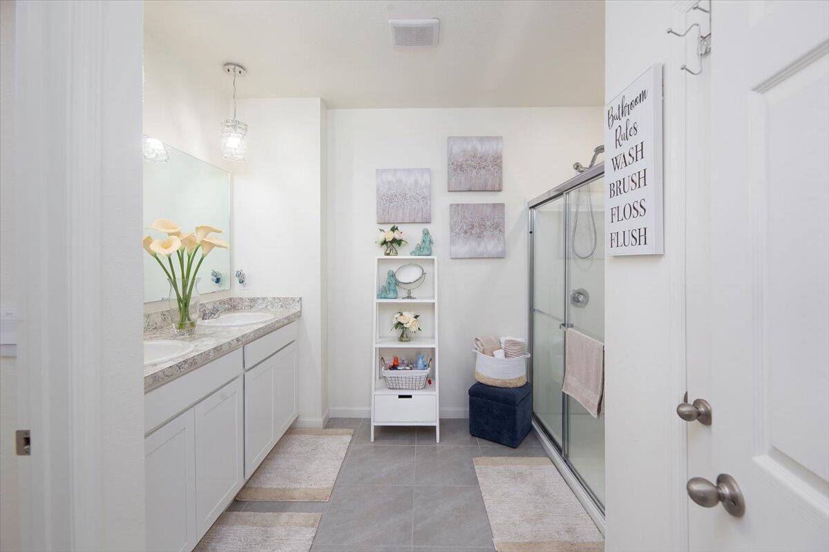 12314 Rimini Way Port St. Lucie, FL 34987 - Photo 28 of 49 a bathroom with a granite countertop sink a toilet and shower