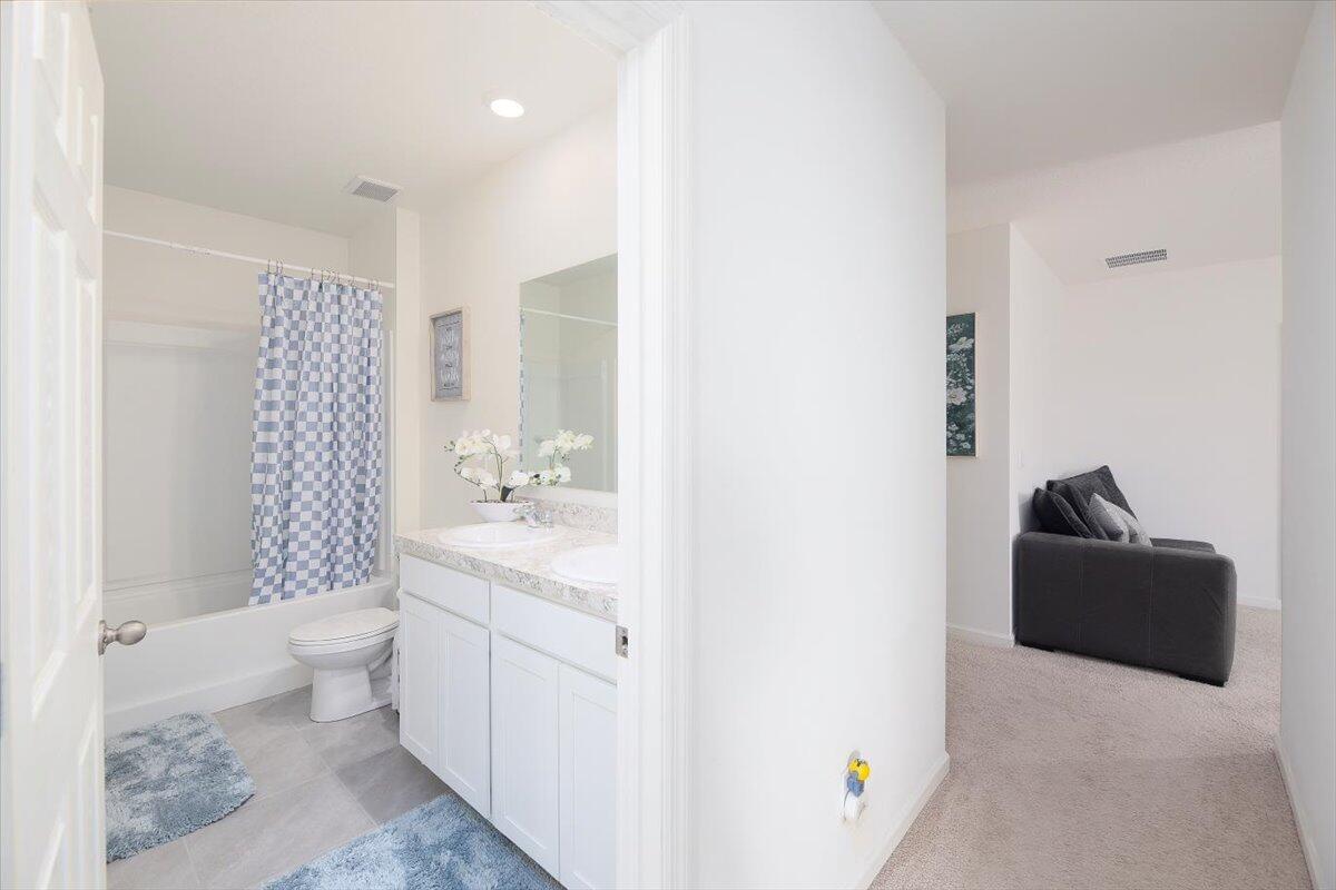 12314 Rimini Way Port St. Lucie, FL 34987 - Photo 36 of 49 a bathroom with a sink toilet and shower