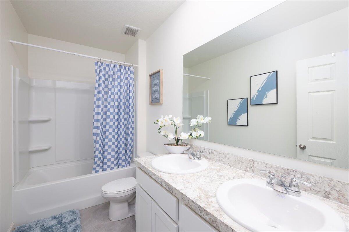 12314 Rimini Way Port St. Lucie, FL 34987 - Photo 37 of 49 a bathroom with a granite countertop sink toilet and shower
