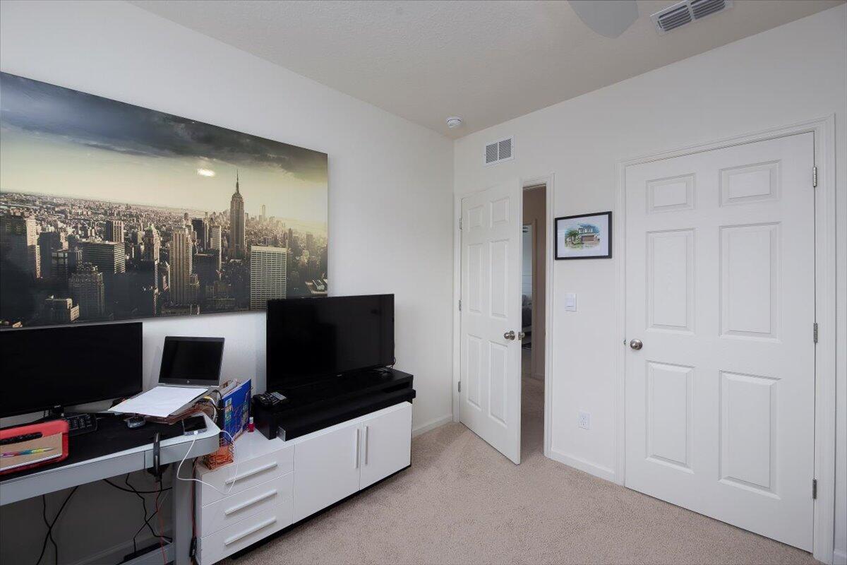 12314 Rimini Way Port St. Lucie, FL 34987 - Photo 38 of 48 a living room with furniture and a flat screen tv