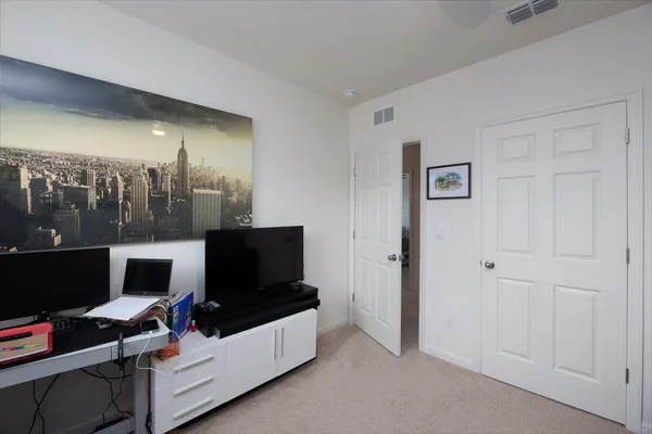 an aerial view of a building with outdoor space swimming pool and tennis court