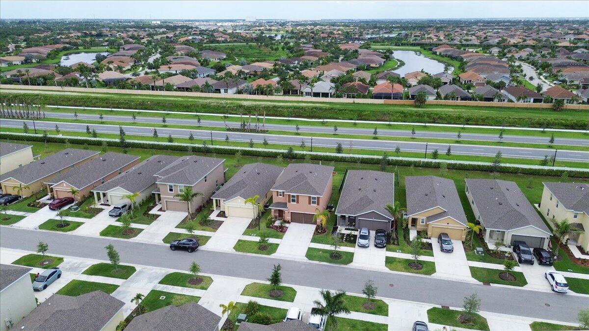 12314 Rimini Way Port St. Lucie, FL 34987 - Photo 43 of 48 an aerial view of a building with outdoor space swimming pool and tennis court