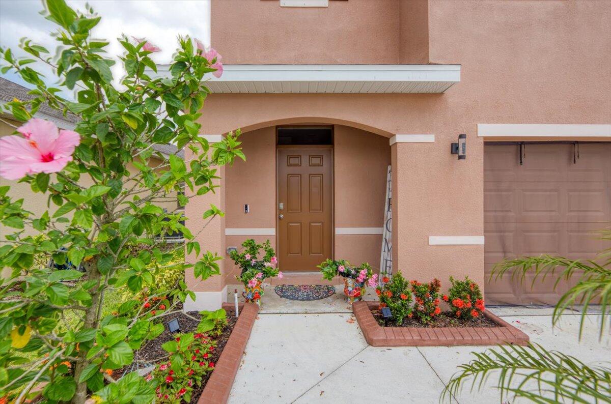 12314 Rimini Way Port St. Lucie, FL 34987 - Photo 5 of 49 a front view of a house with a flower chair