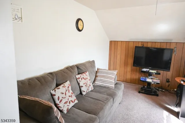 a view of a livingroom with furniture and a flat screen tv